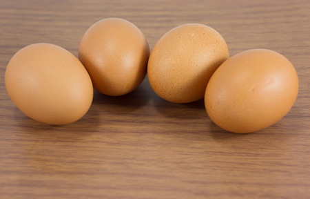 fresh four eggs  on wood tableの写真素材