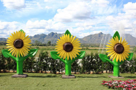 Sunflower Statues On Artificial Grass With Blue Sky Behind the Sceneの写真素材