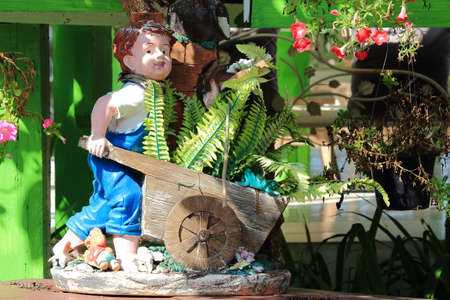 Baked Clay Doll, Boy Pushing Cart That Containing Fernの写真素材