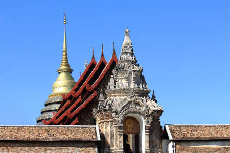 Arch of Temple And Golden Pagoda At Prathat Lampang Luang, Famous Place In Thailandの写真素材