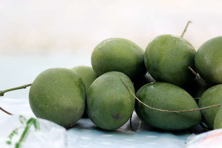 Pile of Green Mangoesの写真素材