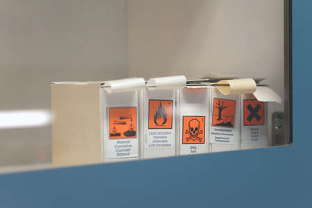 labels with danger signs in a laboratory's showcaseの写真素材
