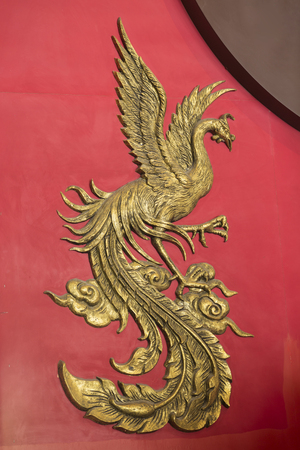 Phoenix carved from wooden in chinese style use color gold and redの写真素材