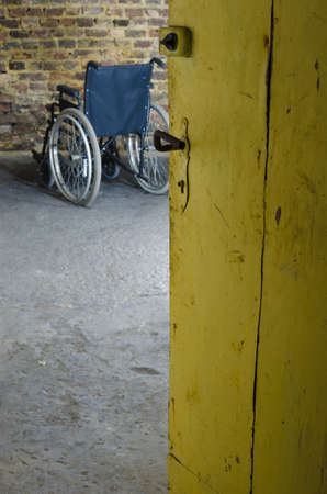 empty wheelchair in old basementの写真素材