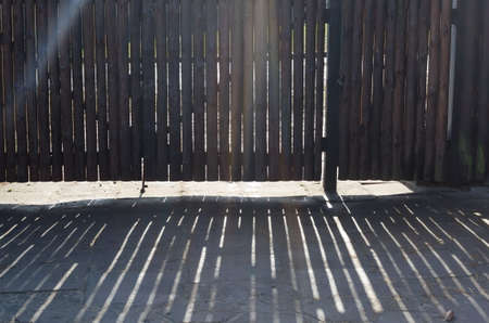 wood gate with sun beamsの写真素材
