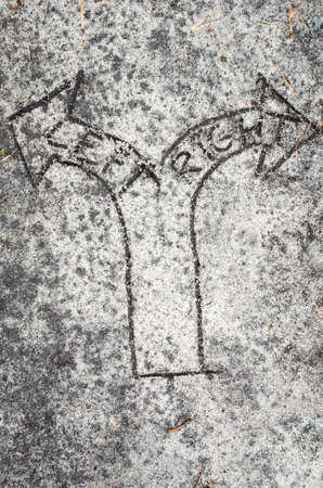 closeup to arrow sign on sand backgroundの写真素材