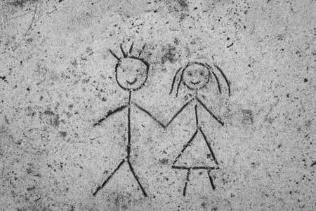 closeup to couple sketching on sand backgroundの写真素材