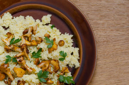 cooked millet groats with chanterelle, girole fungus and parsleyの写真素材