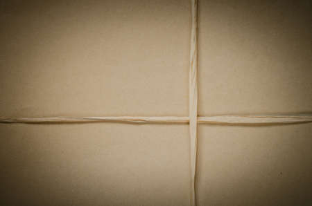 brown cardboard package background tied with twineの写真素材