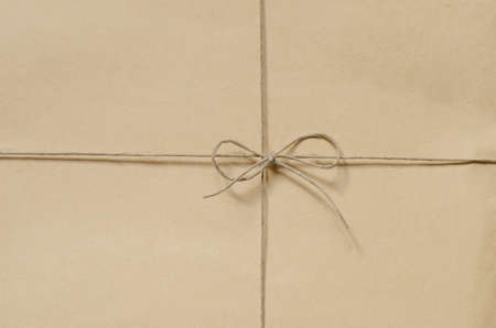 brown cardboard package background tied with twineの写真素材