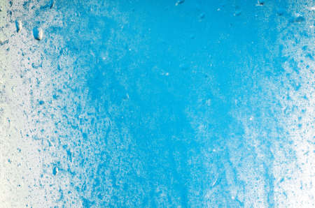 blue winter background frost on window
