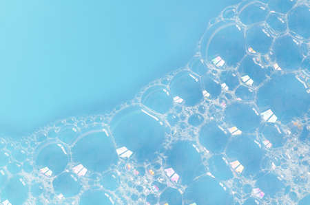 foam bubbles on blue water backgroundの写真素材