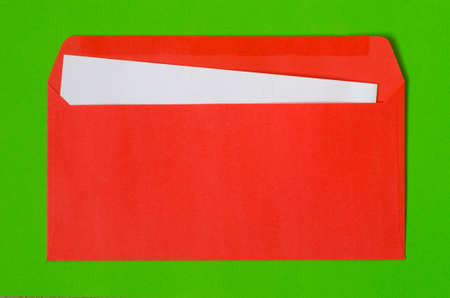 open red envelope with  blank paper on green backgroundの写真素材