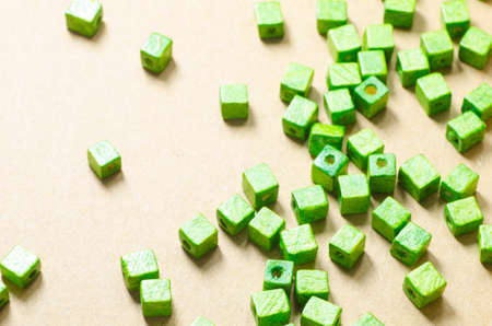 green wooden cubic beads on paper backgroundの写真素材