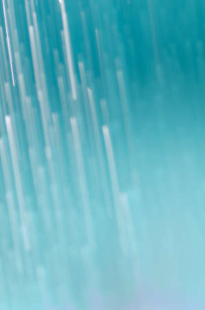 blurred falling water drops blue backgroundの写真素材