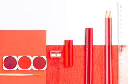 red color school supplies on white paper backgroundの写真素材