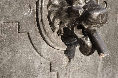 water tap lion's head shaped, Old Town in Warsawの写真素材