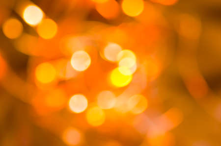 orange abstract blurred bokeh lights backgroundの写真素材