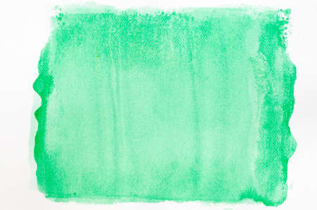 green watercolor painted background texture on white paperの写真素材