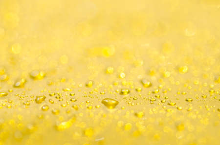 blurred water drops on yellow backgroundの写真素材