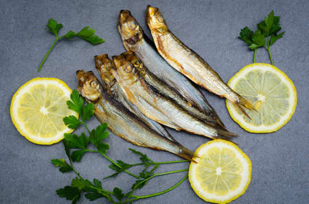 smoked sprats wit parsley and lemonの写真素材