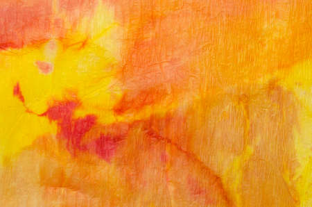 orange watercolor painting on crepe paper background textureの写真素材