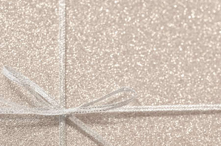 silver  gift ribbon on glittering backgroundの写真素材