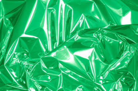 green shiny metallic foil backgroundの写真素材