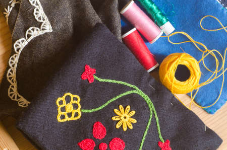 handmade embroidery composition on wooden backgroundの写真素材