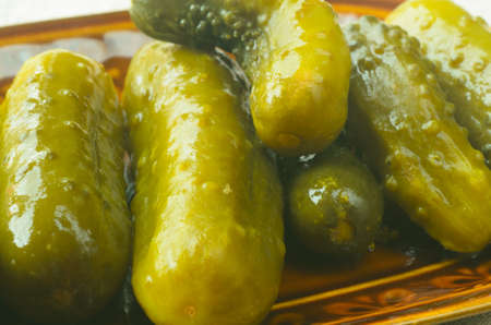 pickled cucumbers in brine on tableの写真素材