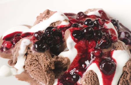 chocolate ice cream with whipped cream and fruits sauceの写真素材