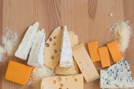 different types of cheese on wooden tableの写真素材