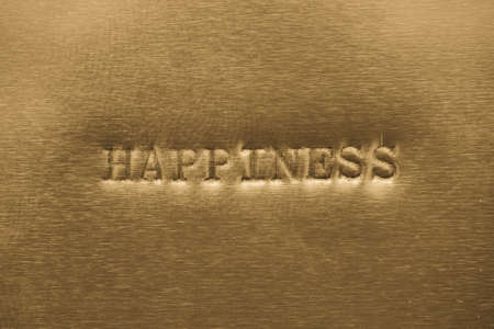 word hapiness  printed on golden metallic backgroundの写真素材