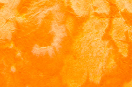orange painted crepe paper background textureの写真素材