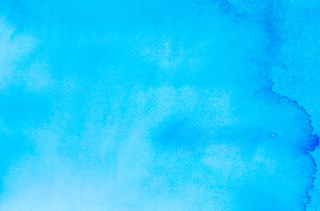 blue watercolor painted on paper backround textureの写真素材
