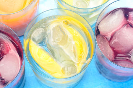 colorful drinks with ice in glassの写真素材