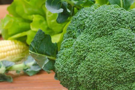 fresh broccoli on wooden table