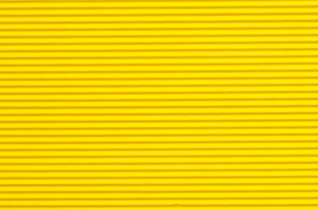 corrugated yellow color paper background textureの写真素材