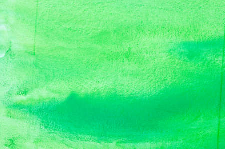 green watercolor painted on paper background textureの写真素材