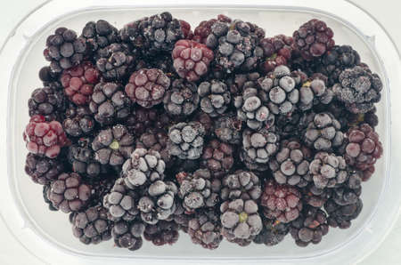 closeup to frozen blackberries in plastic box