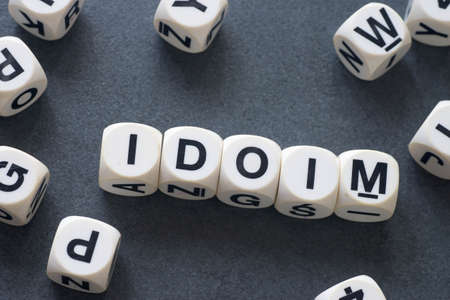 word idiom on white toy cubesの写真素材