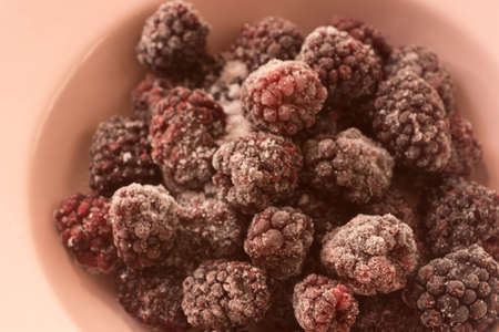closeup to frozen blackberries on plateの写真素材