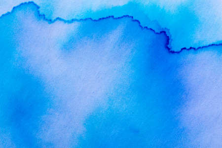 blue watercolor painted on paper backgroundの写真素材