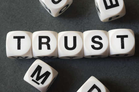 Word trust on white toy cubesの写真素材