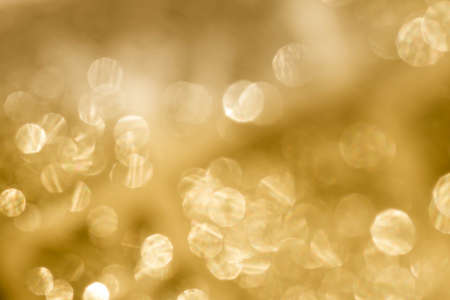 golden abstract blurred lights bokeh background textureの写真素材