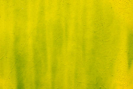 yellow color painted wall background textureの写真素材