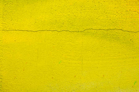 yellow color painted wall background textureの写真素材