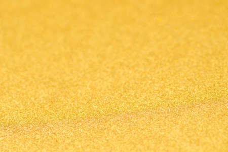 gold color defocused sparkling background textureの写真素材