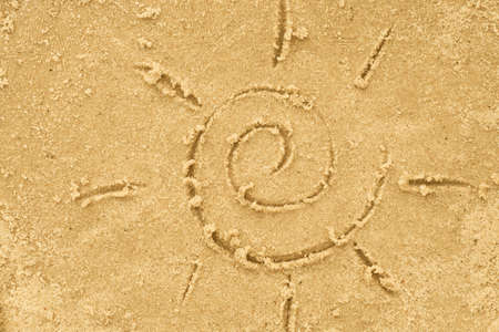 Sun drawing in sand background