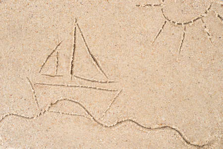 yacht drawing in sand backgroundの写真素材